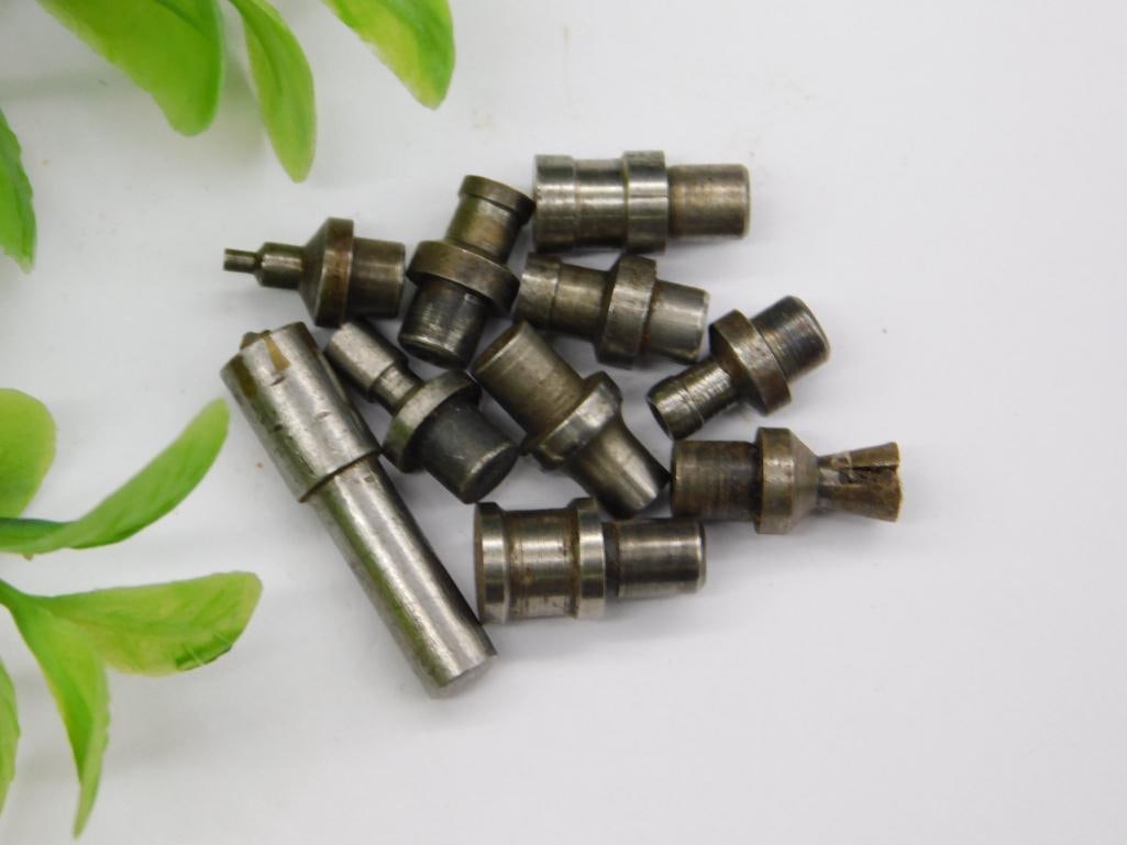 Watchmaker Tool Parts with Threaded and Brass Pieces: Group of small machined steel and brass parts, including threaded shanks and stepped punches with pointed or flared tips, consistent with watchmaker staking or lathe tooling. No maker's marks noted.