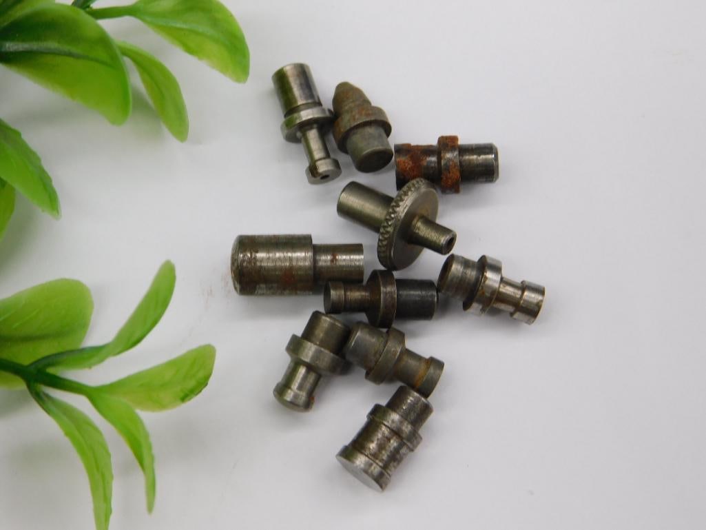 Watchmaker Staking Tool Punch Lot with Coin Scale: Assortment of small steel machined punches/stakes with stepped shafts and pointed, flat, or cupped tips. Light rust visible on a few components; unmarked.