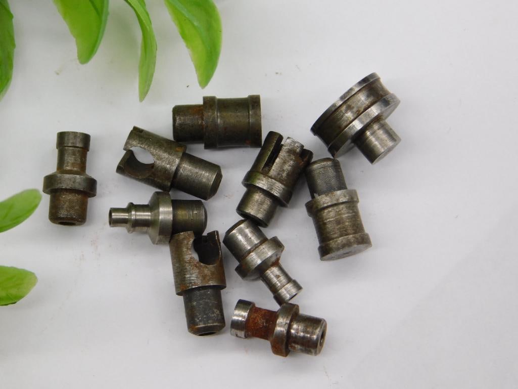 Watchmaker Tool Parts Incl. Forked Hand Remover: Lot of small machined steel parts including forked open-end pieces resembling watch hand or pallet removal tools, alongside stepped-shaft punches with pointed or cupped tips. Light surface rust noted