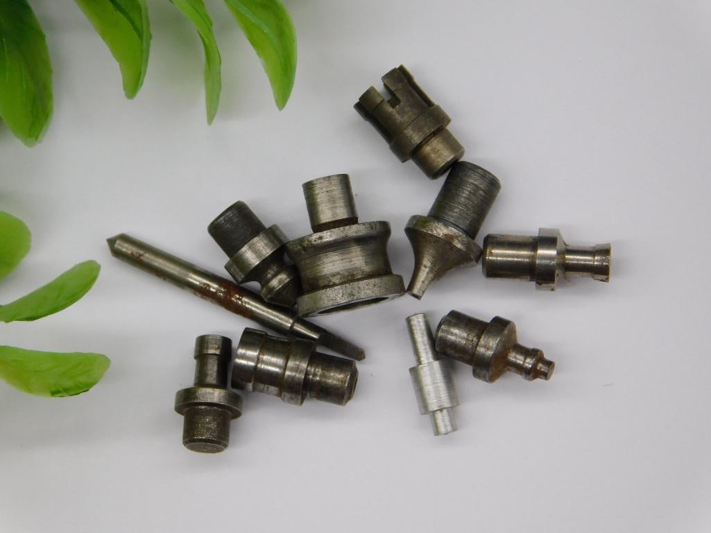 Watchmaker Staking Punches with Marked Rod and Coin Scale: Group of small steel machined parts with pointed, cupped, and forked tips, along with a slender numbered rod. Likely components of a watchmaker's staking tool set; light rust on a few pieces.