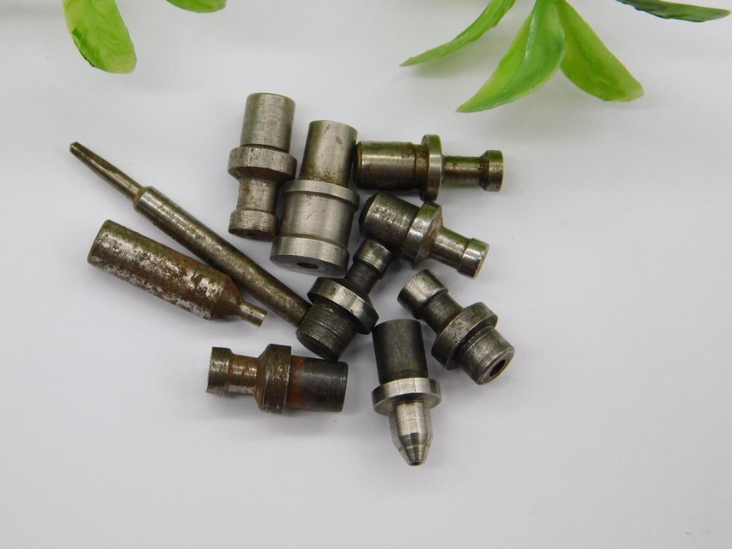 Watchmaker Staking Tool Parts with Coin for Scale: Assortment of small steel machined parts including a knurled-grip handle tool and a forked notched-end piece, alongside stepped punches with cupped or ball tips.