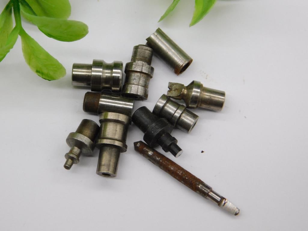 Watchmaker Tool Parts with Rusted Cone-Shaped Piece: Group of small machined steel parts including a rusted cone-shaped fitting and a pointed slender rod tool, plus several stepped punches with cupped or flared tips. Light rust and patina on multiple