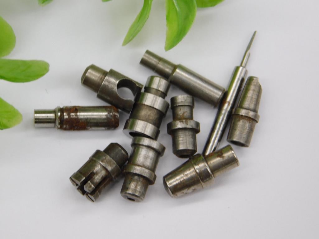 Vintage Watchmaker Tool Parts with Cone-Shaped Funnel: Assortment of small machined steel parts including a cone/funnel-shaped fitting and a slender numbered rod, alongside stepped punches with pointed and cupped tips. Light rust on several pieces. See