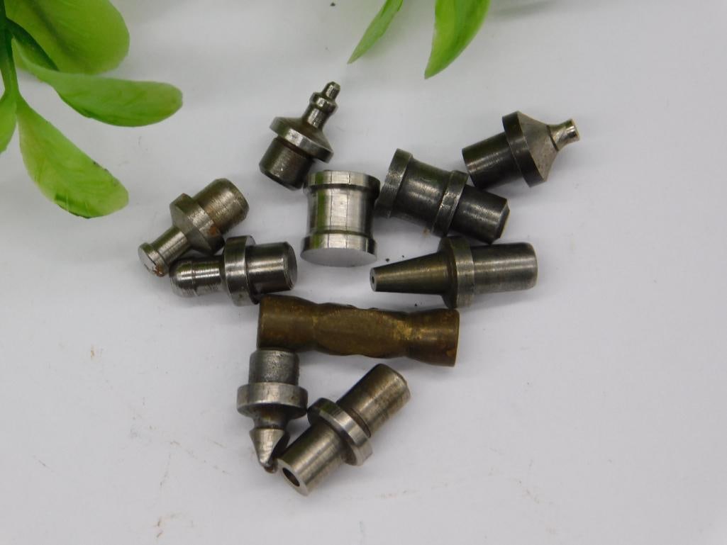 Watchmaker Tool Parts with Brass Ridged Cylinder: Group of small steel machined parts including a brass ridged/knurled cylindrical piece and a rusted cone-shaped tip, along with stepped punches featuring cupped and pointed ends. See photos for exact