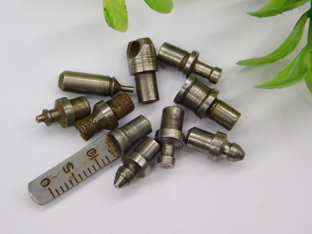 Watchmaker Lathe Parts, Steel & Brass Mix: Assortment of roughly ten stepped steel stakes/punches along with a knurled brass component, likely from a watchmaker's lathe or staking tool set. See photos for exact size and condition.