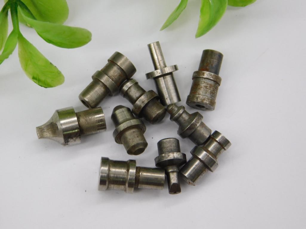 Antique Watchmaker Punch & Stake Assortment: Group of small steel stepped punches and stakes with a mix of bright and lightly rusted finishes, along with a brass fitted piece. Consistent with watchmaker lathe or staking tool accessories. See pho