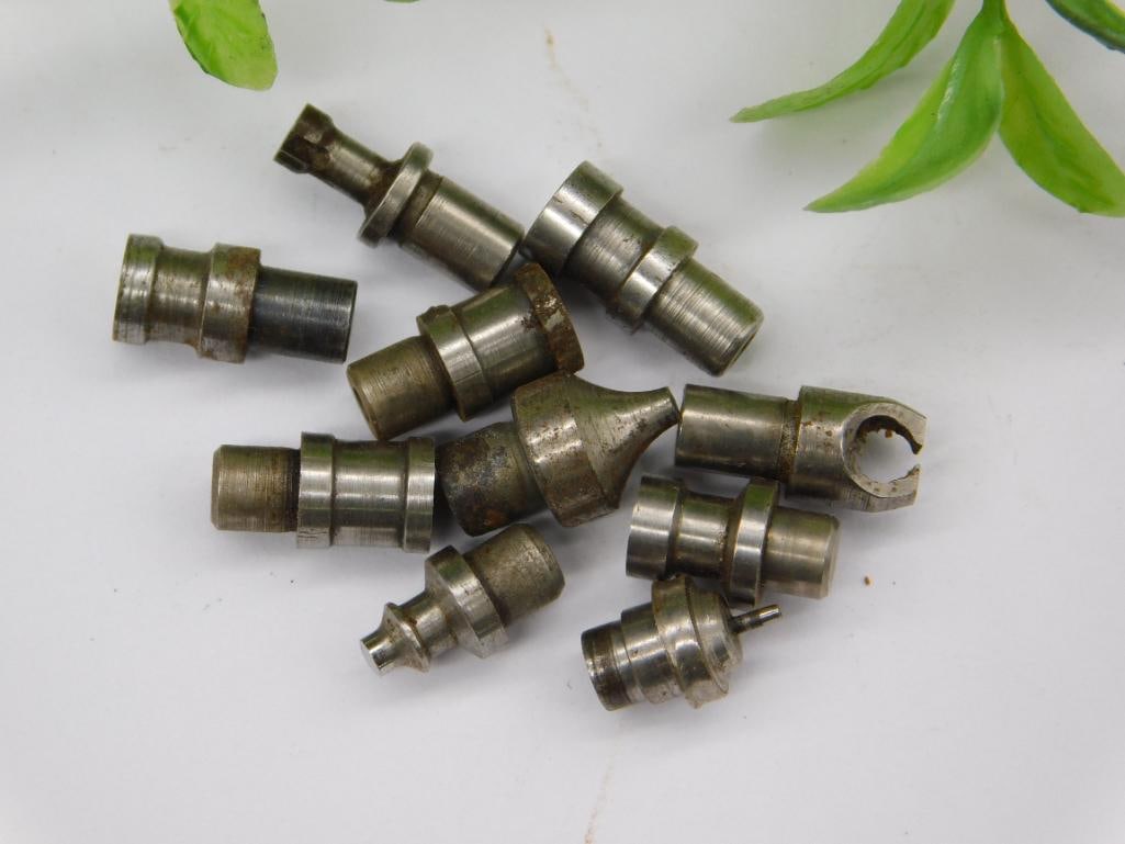 Assorted Watch Tool Punches with Bearing Piece: Group of small steel stepped punches and stakes, plus a small metal ball-bearing style ring and a knurled screwdriver-type piece, likely watchmaker lathe or staking tool components. Some pieces show