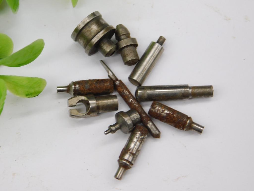 Watchmaker Tool Parts, Forked Stake & Punches: Group of small steel stepped stakes/punches including a forked notched piece and a long pin-tipped tool, consistent with watchmaker lathe or staking accessories, with noticeable surface rust on