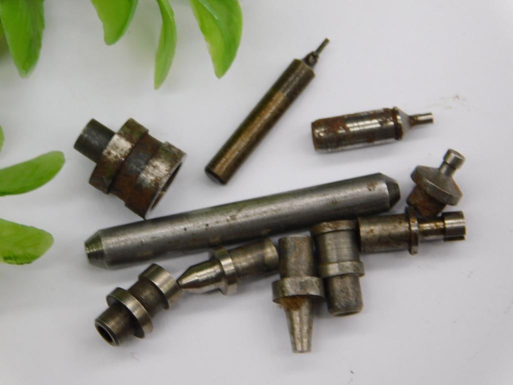 Watchmaker Lathe Parts, Brass Collet & Long Stakes: Group of small steel stepped stakes/punches and a domed cup-shaped fitting, along with a slotted brass collet, consistent with watchmaker lathe or staking tool components; several pieces show surface