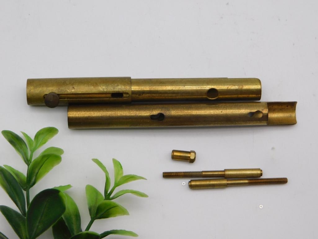 Antique Brass Watchmaker Tool Handles & Screws: Pair of hollowed brass tubular tool handles/barrels (each roughly 5 inches long) with internal slots and pin holes, shown with a small brass collar and two long threaded brass screw/pin rods. Likely w