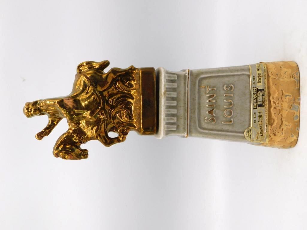 Jim Beam Saint Louis Beam & Specialties Club Equestrian Statue Decanter: A dignified Jim Beam decanter carrying a gold-luster equestrian statue upon a gray stone pedestal lettered Saint Louis the reverse marked Greater Saint Louis Area Beam & Specialties Club above a model