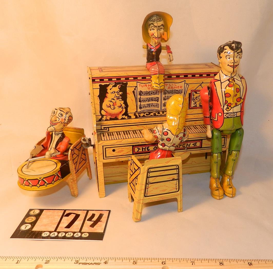 LI'L LIL ABNER AND THE DOGPATCH BAND TIN TOY W/ORIG.: This is an outstanding item that still winds and plays. It comes with the original box in average condition. The paint and graphics are in good shape. Two of the figures are missing one arm.