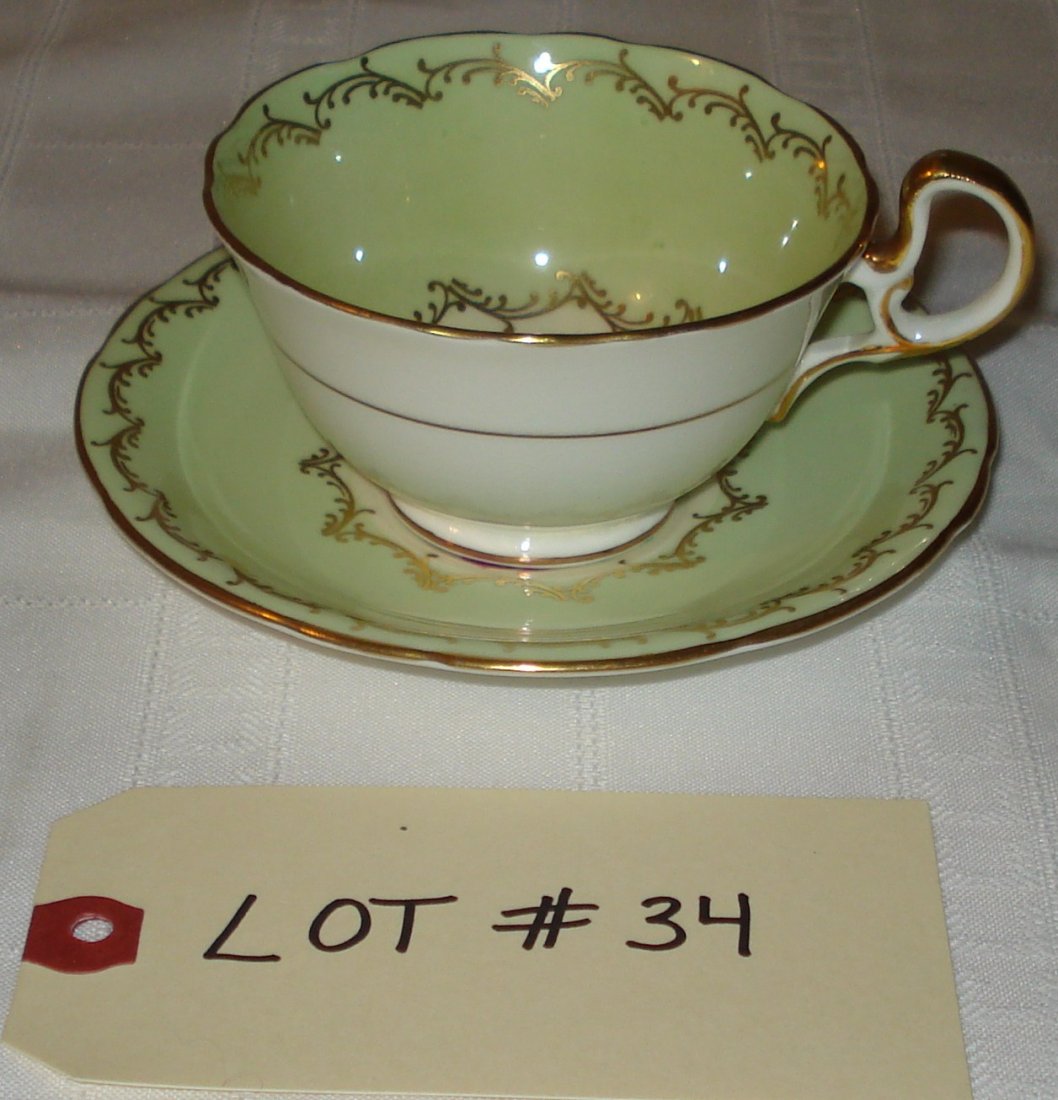 tea cup & saucer: tea cup & saucer (Aynsley bone china, England). green & gold with flower pattern