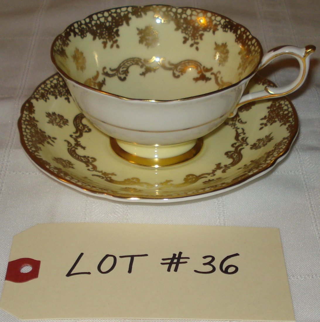 tea cup & saucer: tea cup & saucer (Paragon fine bone china, England). black, yellow & gold.