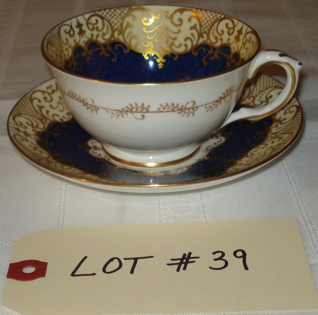 tea cup & saucer: tea cup & saucer (Crown fine bone china, Staffordshire England). #A13990. blue & gold. flower pattern.