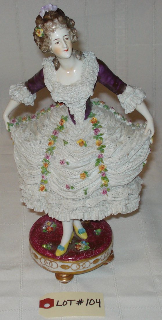 porcelain figurine: vintage porcelain figurine on a footed pedestal with flowers, lady taking a bow (signed N Germany). height:12 inches (30.5cm)
