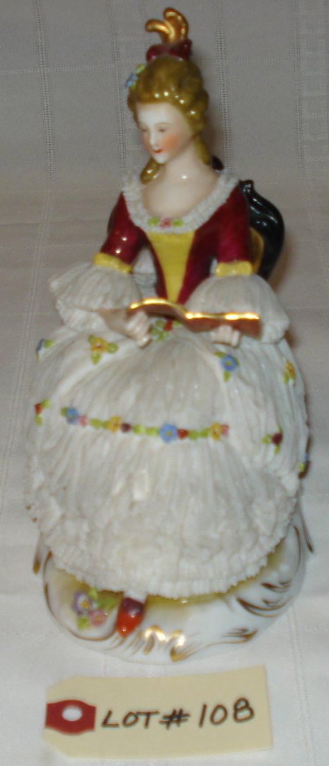porcelain figurine: vintage porcelain figurine (signed N Germany). seated lady reading music sheet. height:7 1/2 inches (19cm)