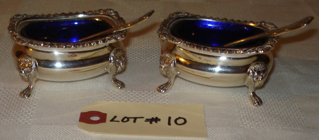 Birks silver salt cellars: silver plated footed salt (or caviar) cellars with lion head and cobalt blue liner. including spoon.