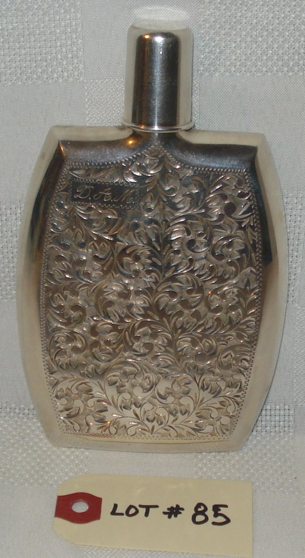 silver flask: silver flask with stopper. D.A.M. monogram on front and "silver" on back. height:6 inches (15 cm)
