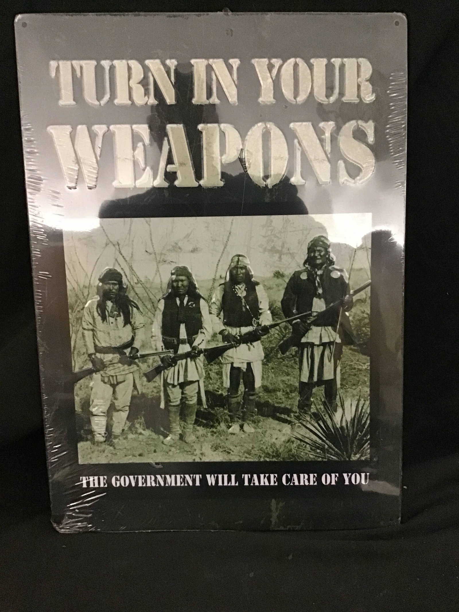 Satire Tin Sign Turn in Your Weapons: length 12 inches across height is 17 inches tall