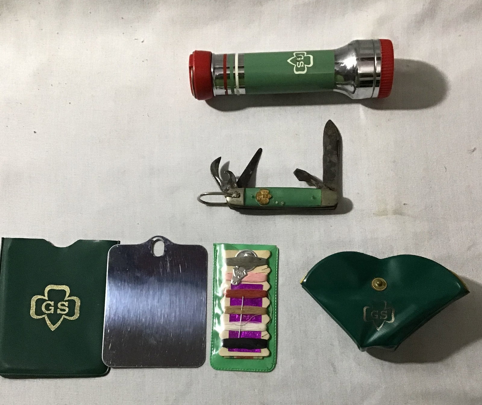 Girl Scouts of America Necessities Collection: flashlight, pocket knife mirror, and sewing kit