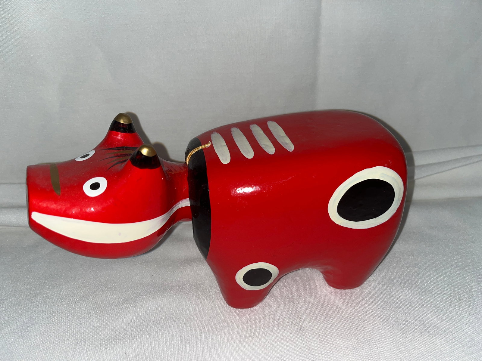 Akabeko The Legendary Red Cow: Paper Machete Arts Toy with bobbing head. Measures 5 1/2 inches tall by 10 1/2 inches long by 4 1/2 inches wide