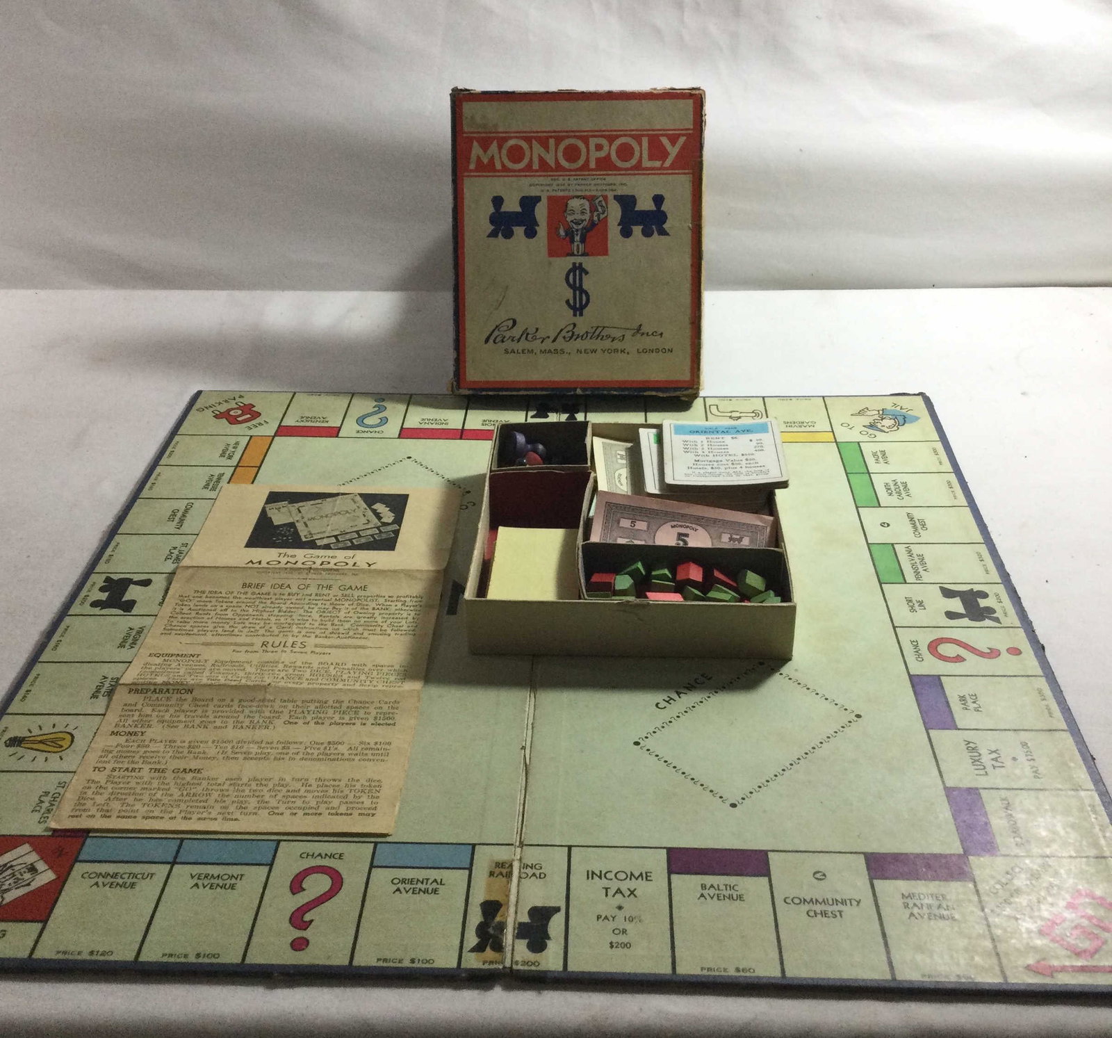 Family Games Collection: Monopoly, game of pick up sticks, Perquackey,and cribbage board.
