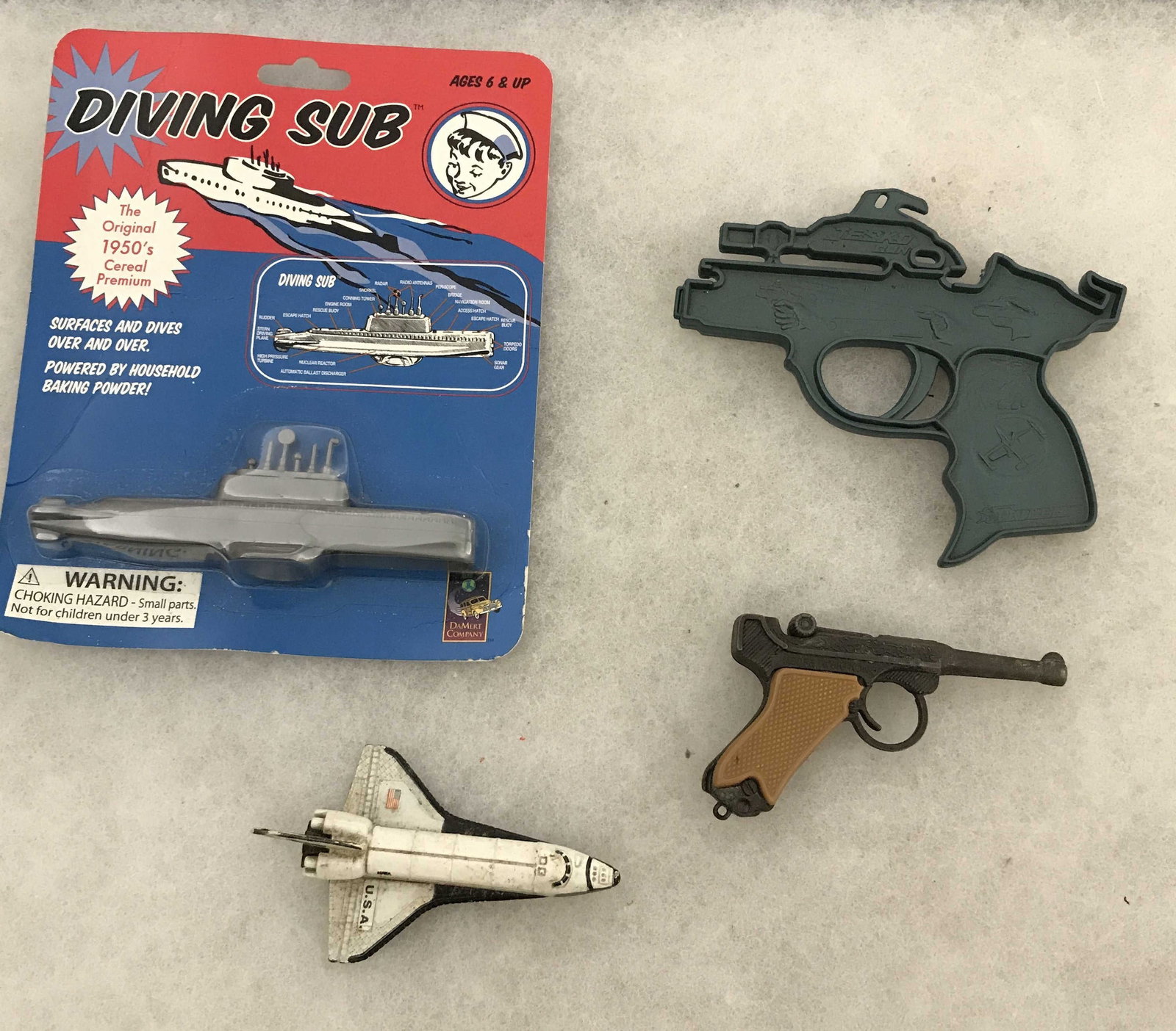 Vintage Toy Collection -diving sub from the 50s,: plastic rubber band pistol toy metal, Luger pistol, and a metal space shuttle, space shuttle is 3 inches long