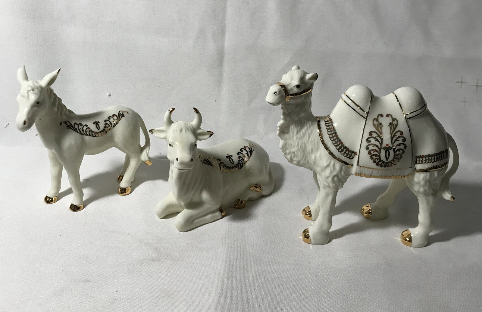 Set of 3 Jade Porcelain Animals, camel donkey: and cow measurements 4 1/2 to 6 inches high, for a nativity scene or whatever
