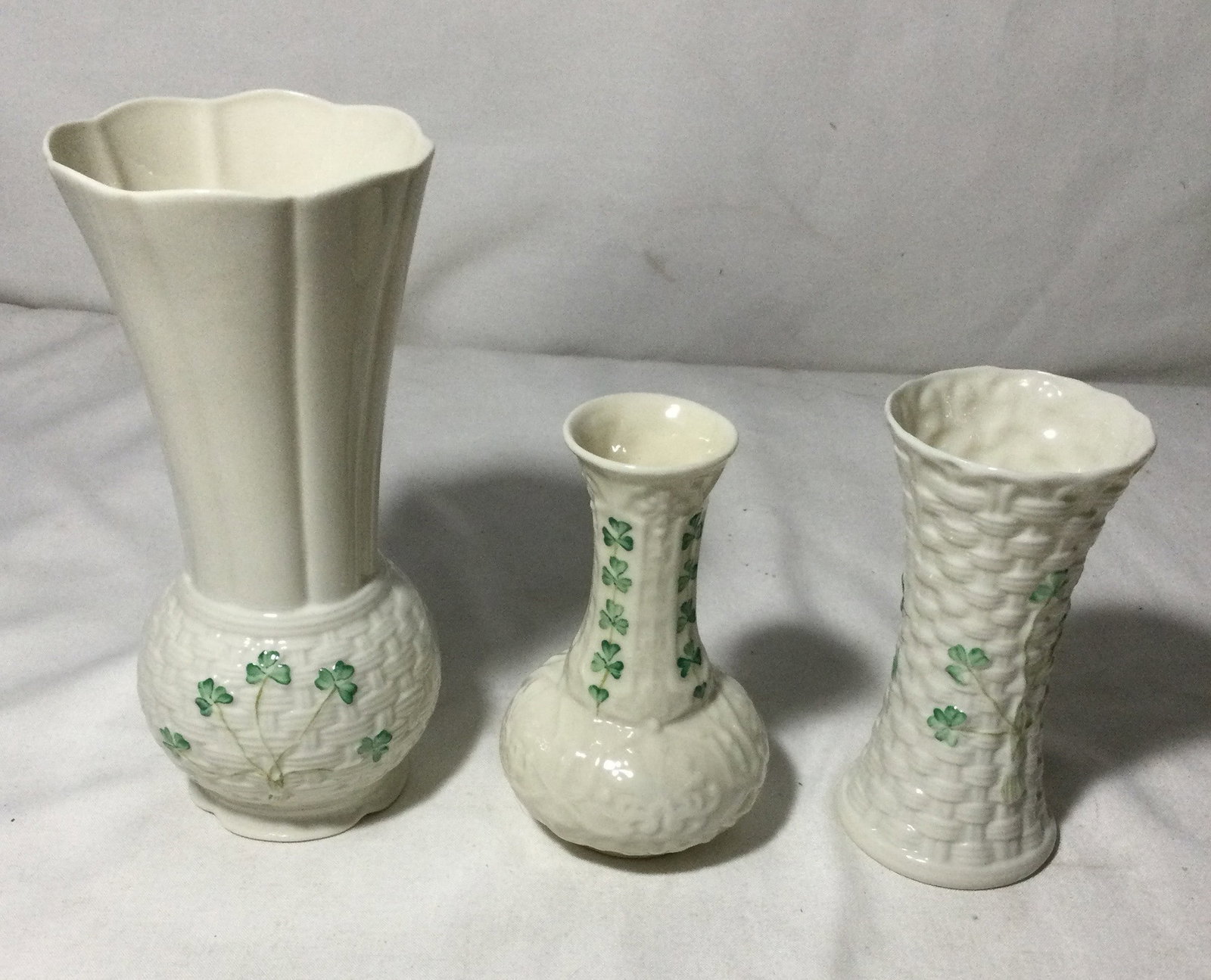 BELLEEK Shamrock Vases (3): Basket weave pattern and hand painted shamrocks they are made in Ireland, measurements are 8 inches tall, 5 1/2 inches & 5 inches tall. No chips or cracks