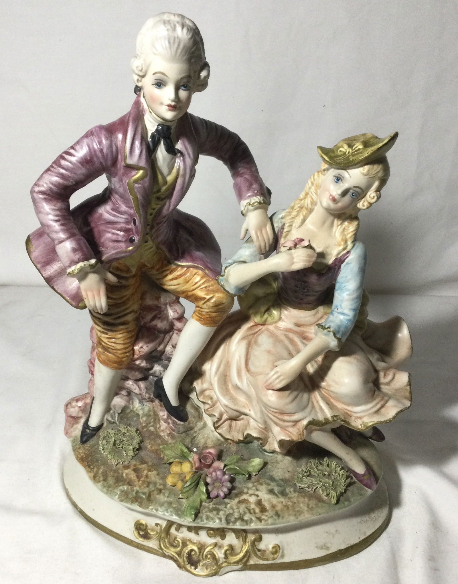 Capodimonte Victorian Couple: Italian porcelain figurine of Victorian couple, measures 14 inches tall and 10 1/2 at the base, Made in Italy,
