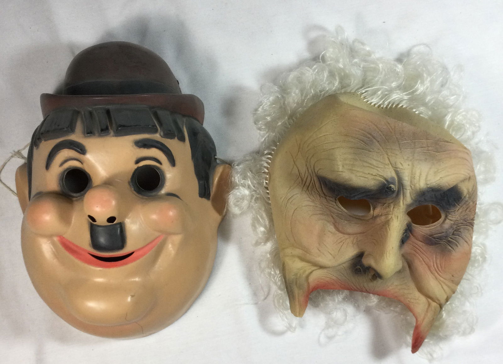 Vintage Halloween Masks: Plastic Hardy mask and rubber old man mask. Crack on bottom left of Hardy mask