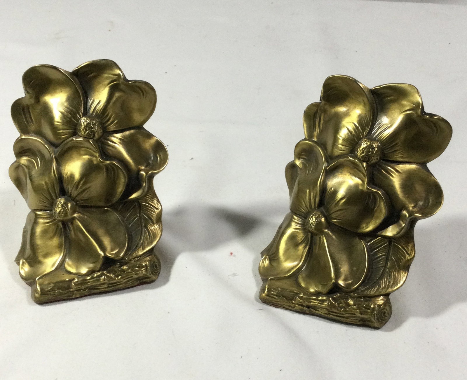 Brass Bookends with Flower Design: Measures 5 1/2 inches tall by 3 1/2 inches at the base
