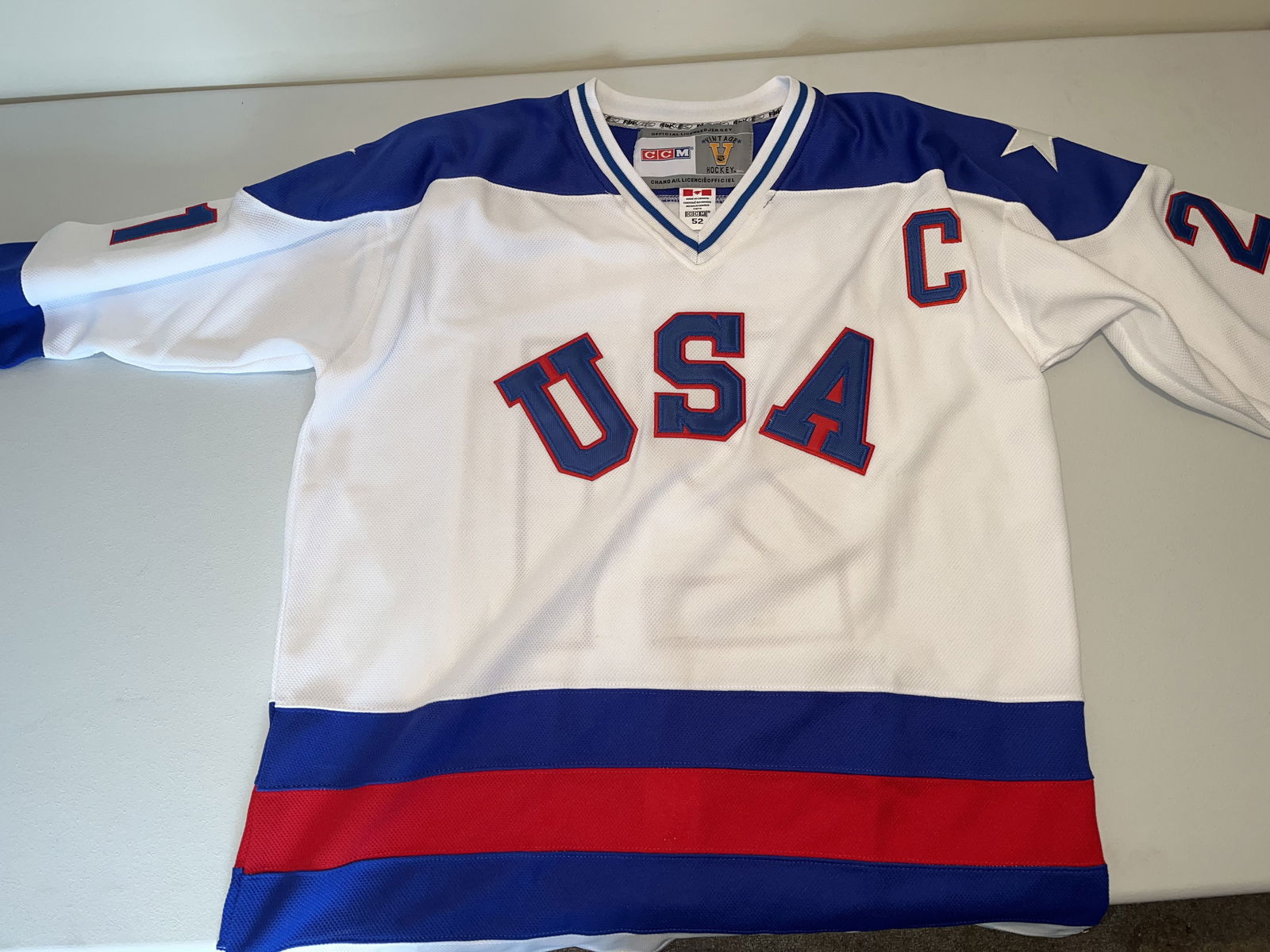 Vintage Hockey Team USA 1980 Olympic Miracle on Ice Mike Eruzione Jersey: This is a CCM Vintage Hockey series reproduction of the 1980 Team USA Olympic jersey as worn by Mike Eruzione. The white mesh jersey features USA in tackle twill across the chest with a captain C on