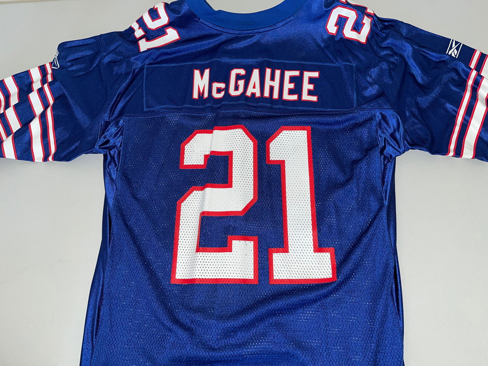Willis McGahee Buffalo Bills Reebok Jersey Large: Willis McGahee Buffalo Bills royal blue replica jersey by Reebok, circa 2003-2006. Features screen-printed nameplate and number 21 on a 100% nylon mesh body with an embroidered NFL shield at the colla