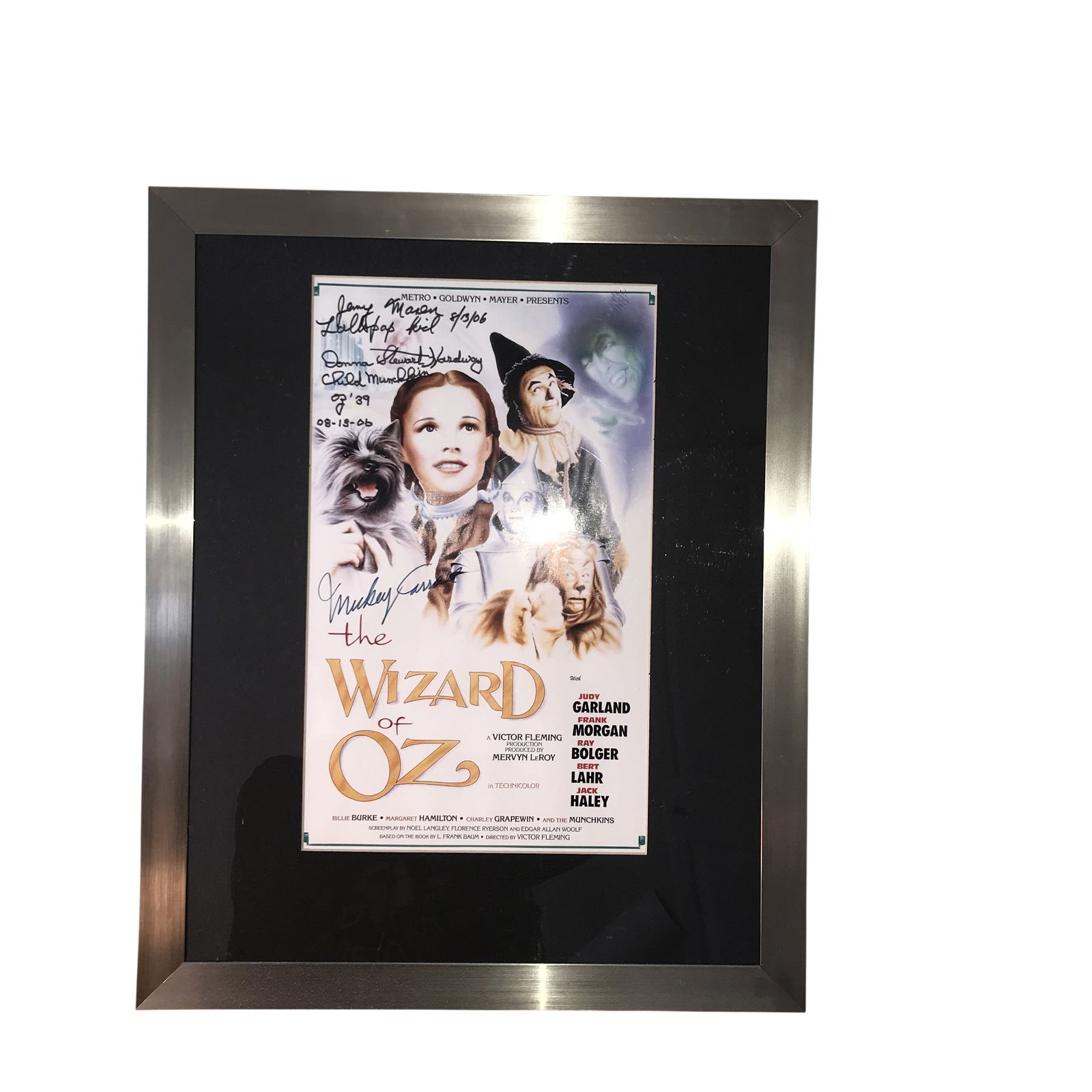 Framed The Wizard of Oz Promotional Poster Autographed by Three Munchkin Cast Members: This lot consists of a framed promotional poster for the 1939 Metro-Goldwyn-Mayer production of The Wizard of Oz. The item bears three handwritten signatures from original Munchkin cast members. In