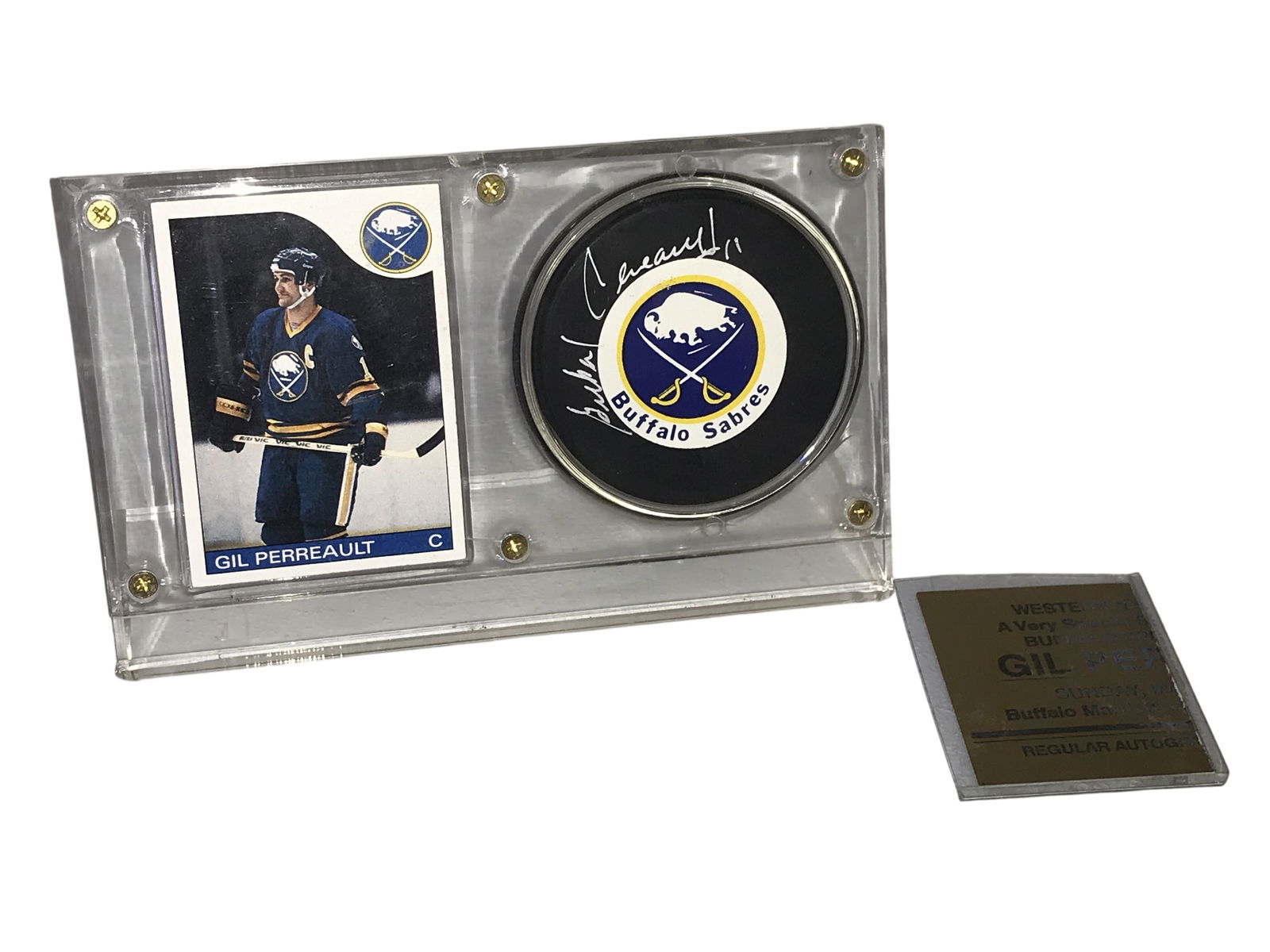 Gil Perreault Autographed Buffalo Sabres Hockey Puck and 1985 Topps Trading Card Display: This Buffalo Sabres memorabilia display features a hockey puck hand-signed by Hall of Famer Gil Perreault in silver-toned ink including his jersey number 11. The puck is an official licensed product m