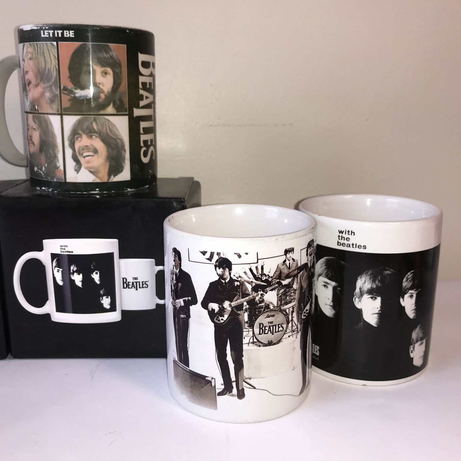 A Collection of Seven Pieces of Apple Corps Ltd. The Beatles Branded Drinkware: This collection consists of officially licensed Apple Corps Ltd. merchandise featuring imagery related to the British rock band, The Beatles.