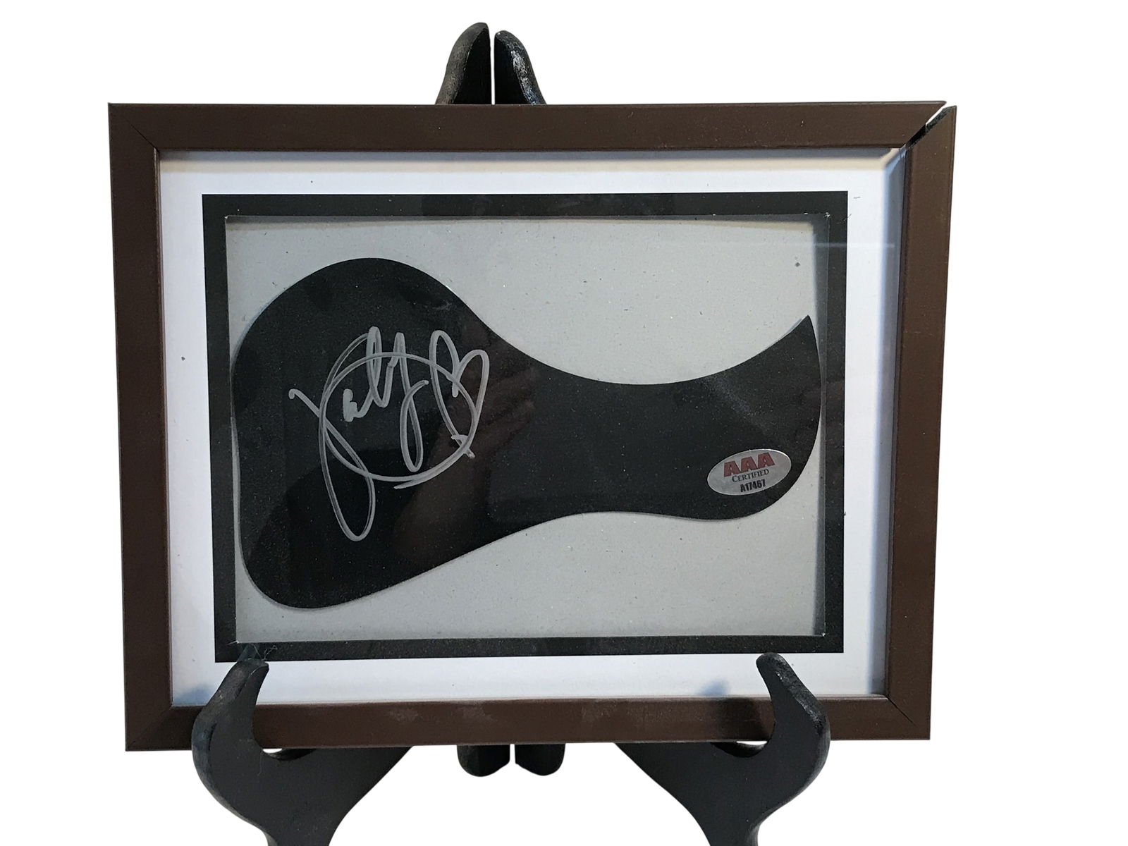 Katy Perry Signed Acoustic Guitar Pickguard with AAA Certification: A black plastic acoustic guitar pickguard bearing the signature of American singer-songwriter Katy Perry. The signature is applied in silver-toned ink and consists of the name Katy followed by a large