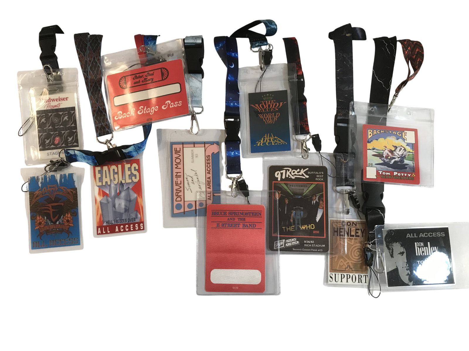 A Collection of Vintage Rock and Pop Concert Backstage Passes and Lanyards: An assortment of concert backstage passes, tour personnel credentials, and a souvenir patch produced by Otto Printing and Entertainment Graphics between 1982 and 1997. The collection includes passes f
