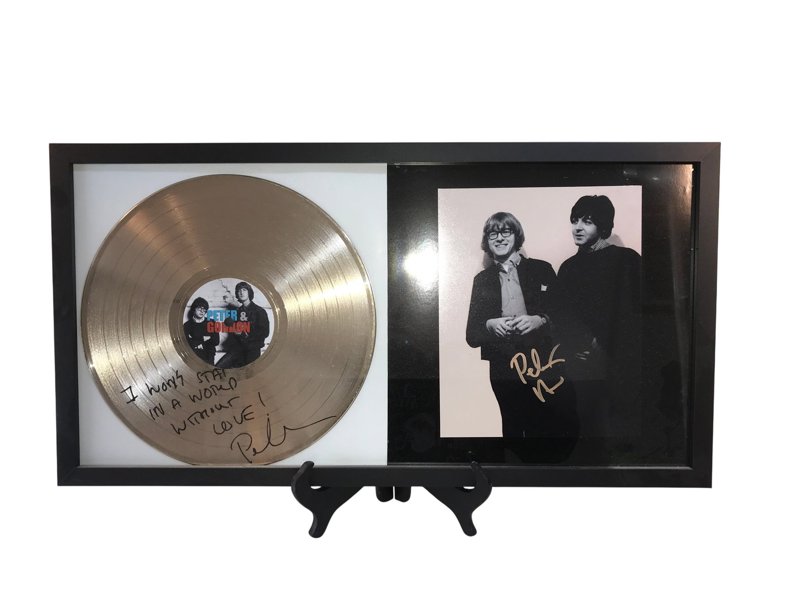 Peter Asher Autographed Framed Display with Souvenir Gold Record and Photograph: A professionally framed memorabilia display featuring two items autographed by musician Peter Asher, known as half of the British Invasion duo Peter & Gordon. The display consists of a 12 inch gold to