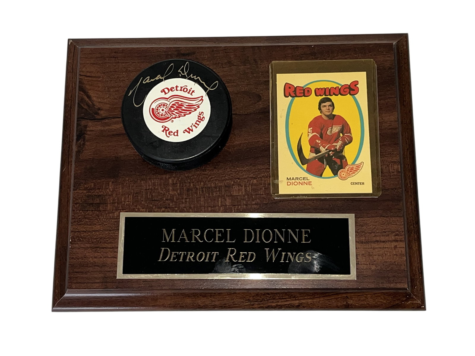 Marcel Dionne Detroit Red Wings Signed Puck and Trading Card Commemorative Plaque: Marcel Dionne Detroit Red Wings commemorative wall plaque featuring an autographed hockey puck and vintage trading card. The assembly includes a hand-signed puck with team logo decal, a 1974-75 Topps