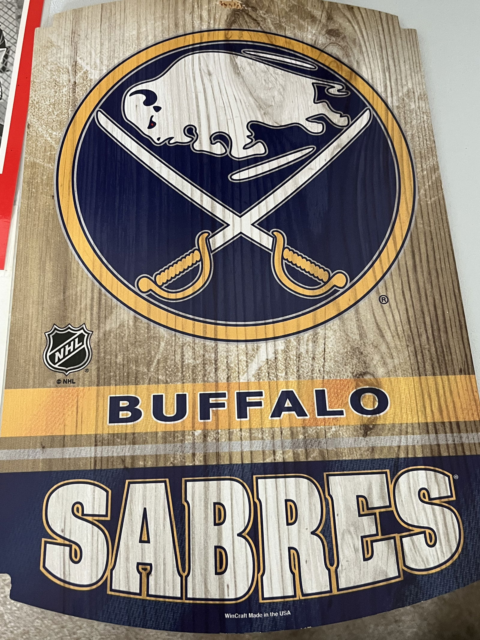 A Collection of Buffalo Sabres NHL Promotional Posters and WinCraft Wood Sign: A collection of Buffalo Sabres NHL memorabilia including promotional paper pieces and a decorative wall sign, circa 1993-1997. The group features a 1993 Stanley Cup Playoffs Fast and Fuhrious commemor