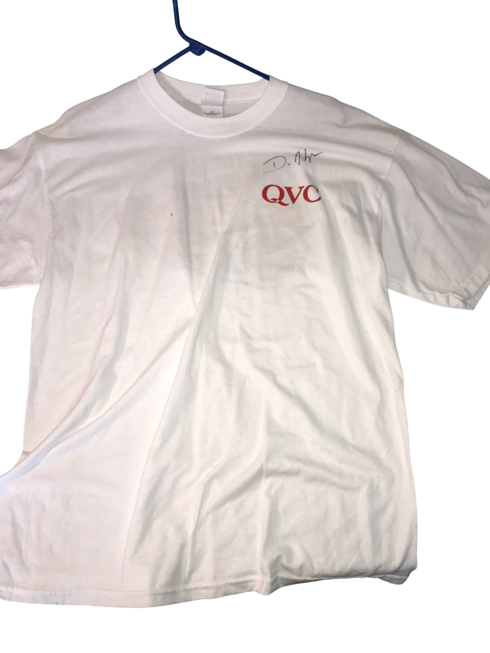 QVC For Race Fans Only Promotional T-Shirt with Unidentified Signature: QVC promotional T-shirt for the program For Race Fans Only, likely late 20th century. The white cotton-blend garment features a red silkscreened QVC logo on the front and a large multi-colored motorsp