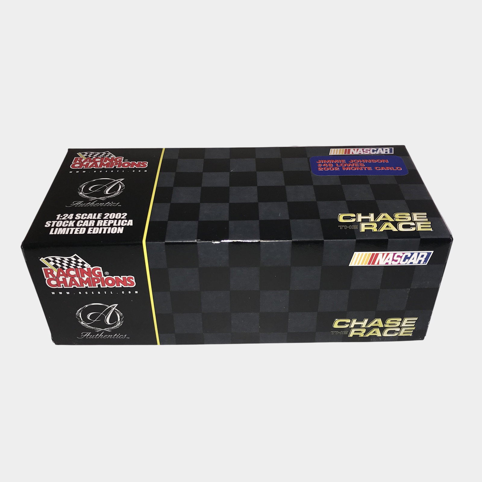 Racing Champions Johnson #48 Lowe's 2002 Chevrolet Monte Carlo: This lot consists of a Racing Champions Authentics 1:24 scale die-cast replica of the #48 Lowe's Chevrolet Monte Carlo driven by Jimmie Johnson during the 2002 NASCAR season. The model is part of the