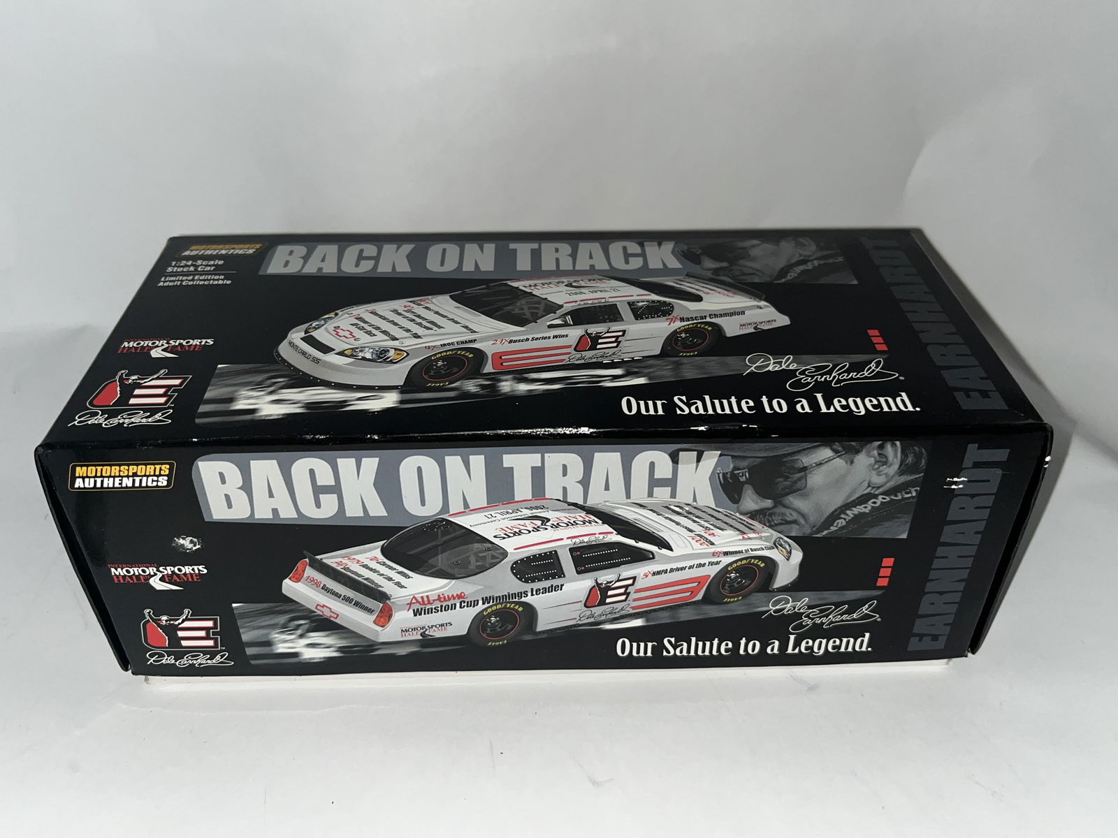 Motorsports Authentics Dale Earnhardt Sr Tribute Die-Cast Signed by Dale Earnhardt Jr: A 1:24 scale die-cast model of a Chevrolet Monte Carlo SS manufactured by Motorsports Authentics. This vehicle is part of the Back on Track series titled Our Salute to a Legend, produced to commemorat