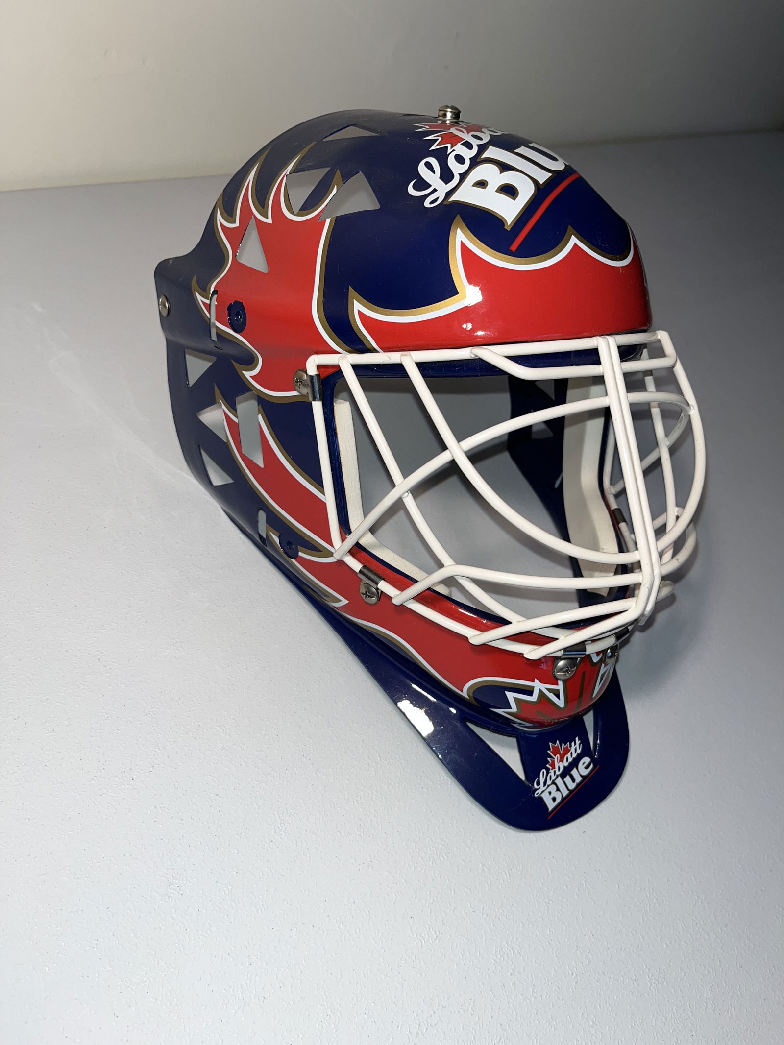 Labatt Blue Promotional Replica Hockey Goalie Mask, circa 1990s: This is a full-size replica hockey goalie mask produced as a promotional advertising item for Labatt Blue. These masks were popular breweriana collectibles and bar display pieces throughout the 1990s.