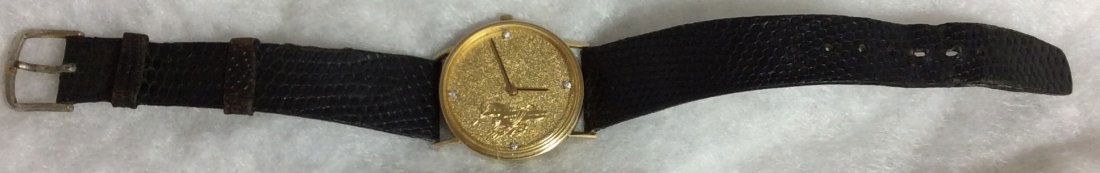 14kt. Men's Watch: 4 seperate diamonds, with angels holding lightning bolts. NOT working currently