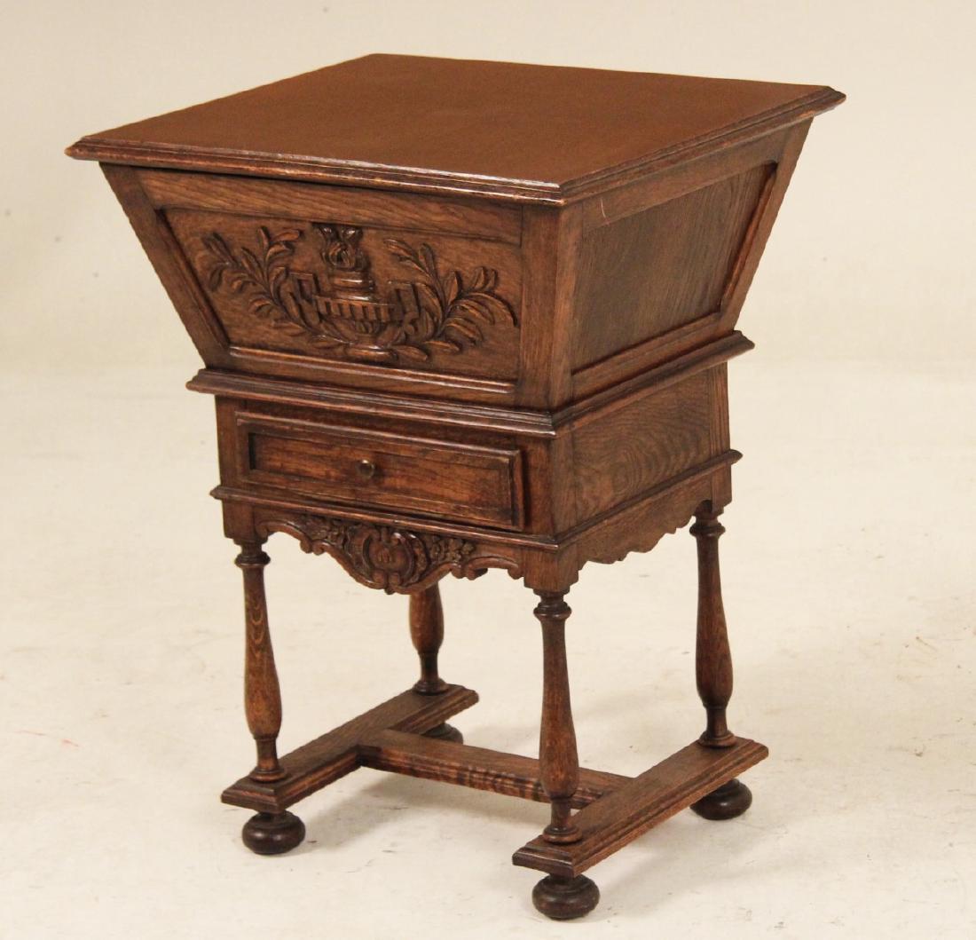PROVINCIAL FRENCH OAK LIFT TOP WINE CABINET: PROVINCIAL FRENCH OAK LIFT TOP WINE CABINET ON STAND HAVING CLASSICAL URN AND FLAME CARVED FRIEZE OVER ONE DRAWER ON A TURNED LEG AND "H" FORMED STRETCHER STAND; 28"H X 22"W X 19"D