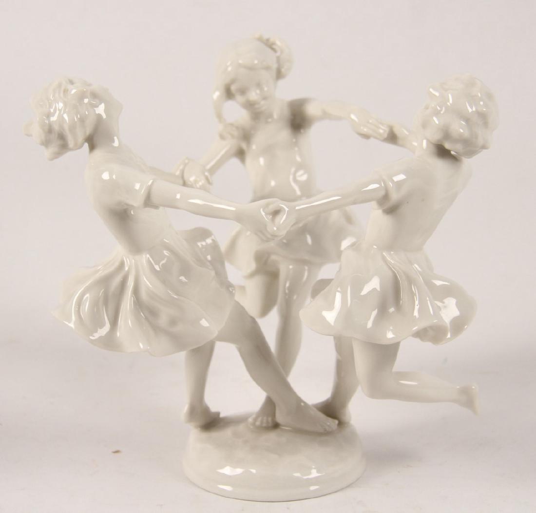 HUTCHENREUTHER SELB BLANC DE CHENE PORCELAIN FIGURINE: HUTCHENREUTHER SELB BLANC DE CHENE PORCELAIN FIGURINE OF 3 YOUNG GIRLS PLAYING AND HOLDING HANDS MARKED IN GREEN ON REVERSE UNDERGLAZE WITH LION AND LETTERS L.H.S. ENCLOSED BY CIRCLE OVER BAVARIA GERM